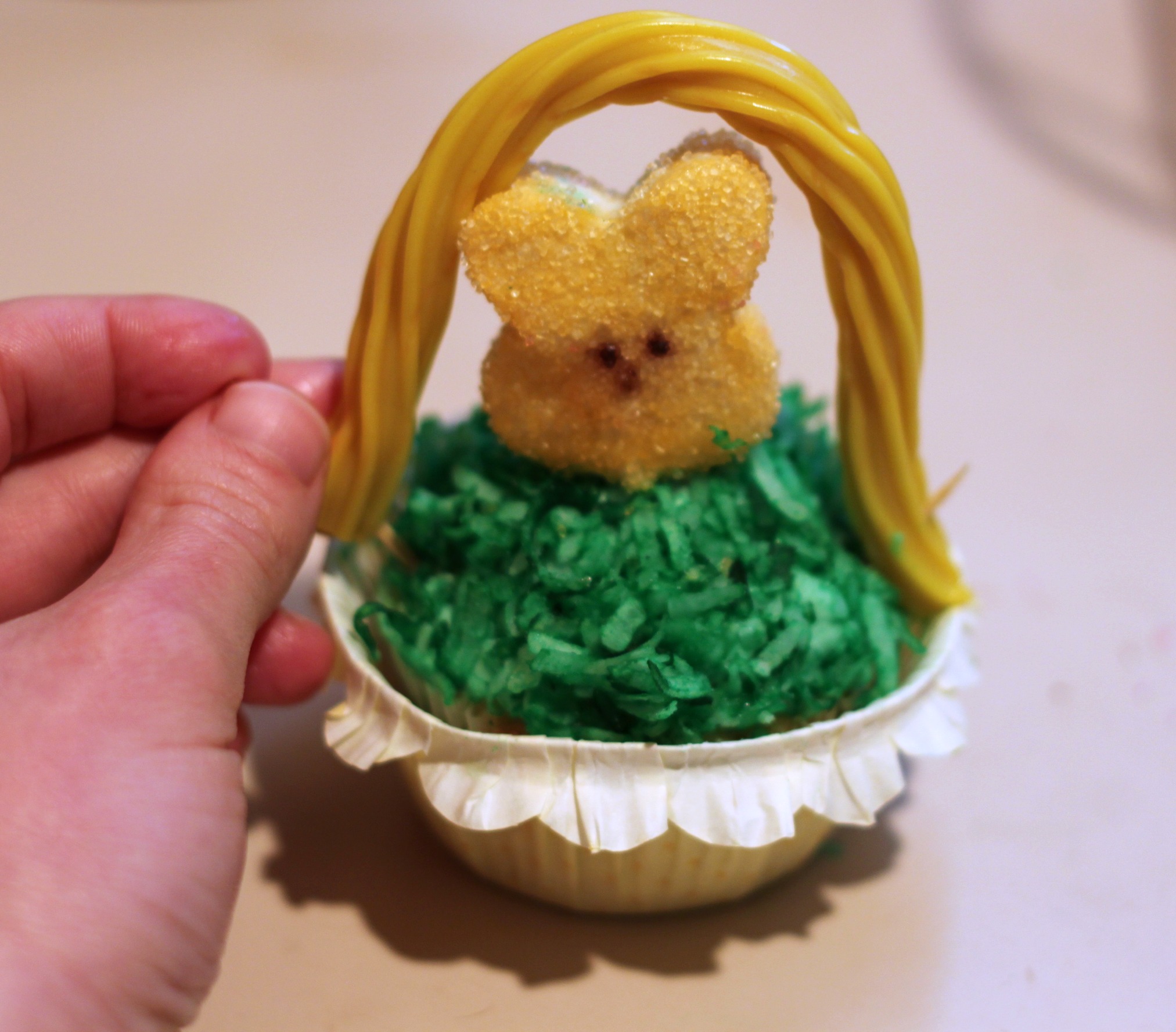 Put Twizzler onto Peepcake to make Easter basket cupcake