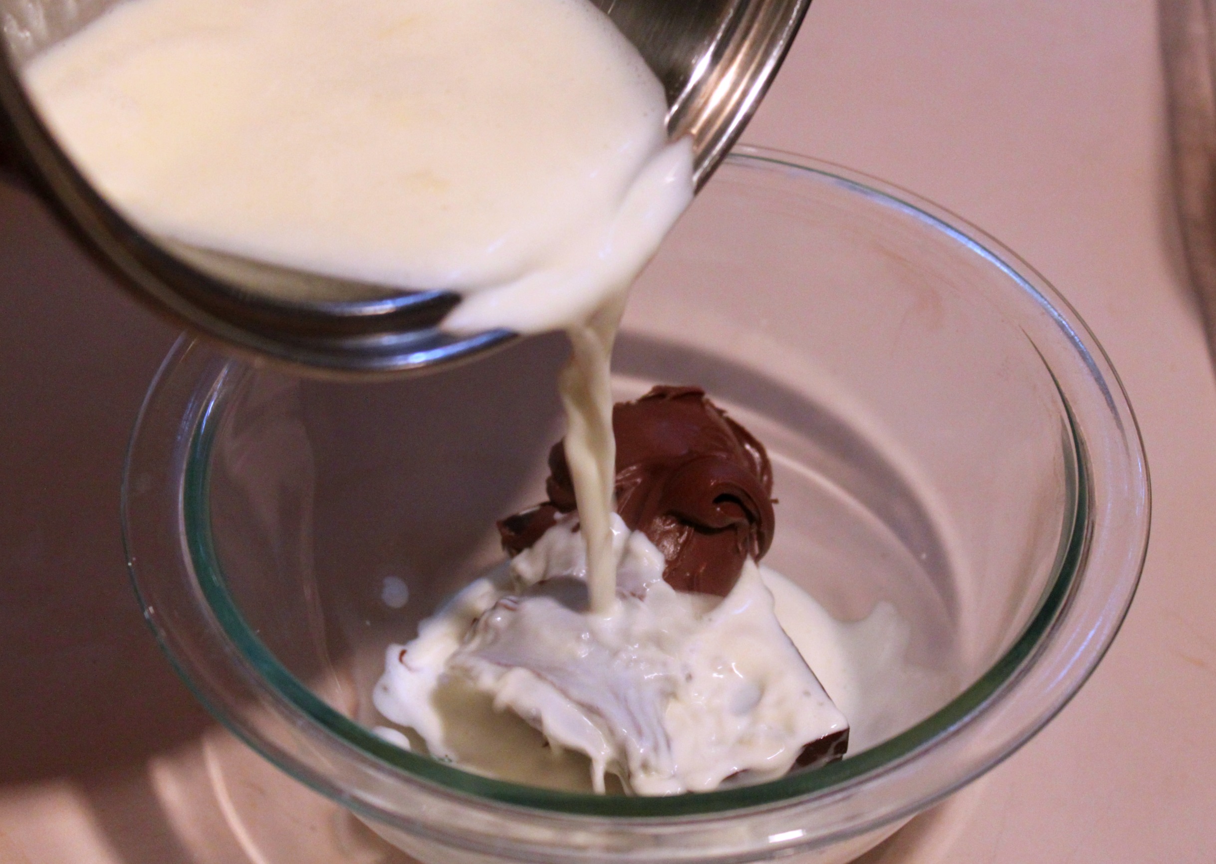 Pour warm cream over Nutella and chocolate