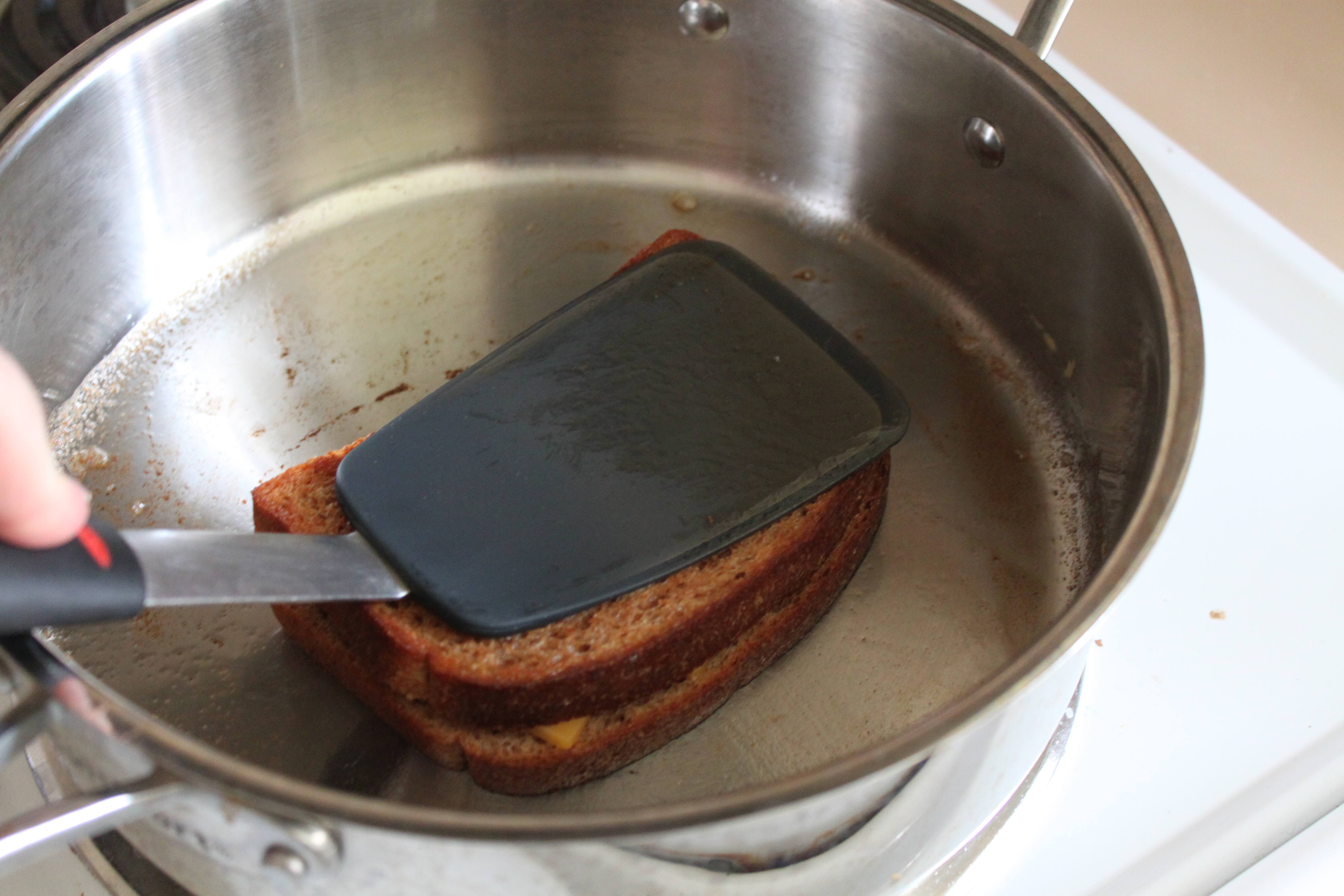 Press down on sandwich with spatula