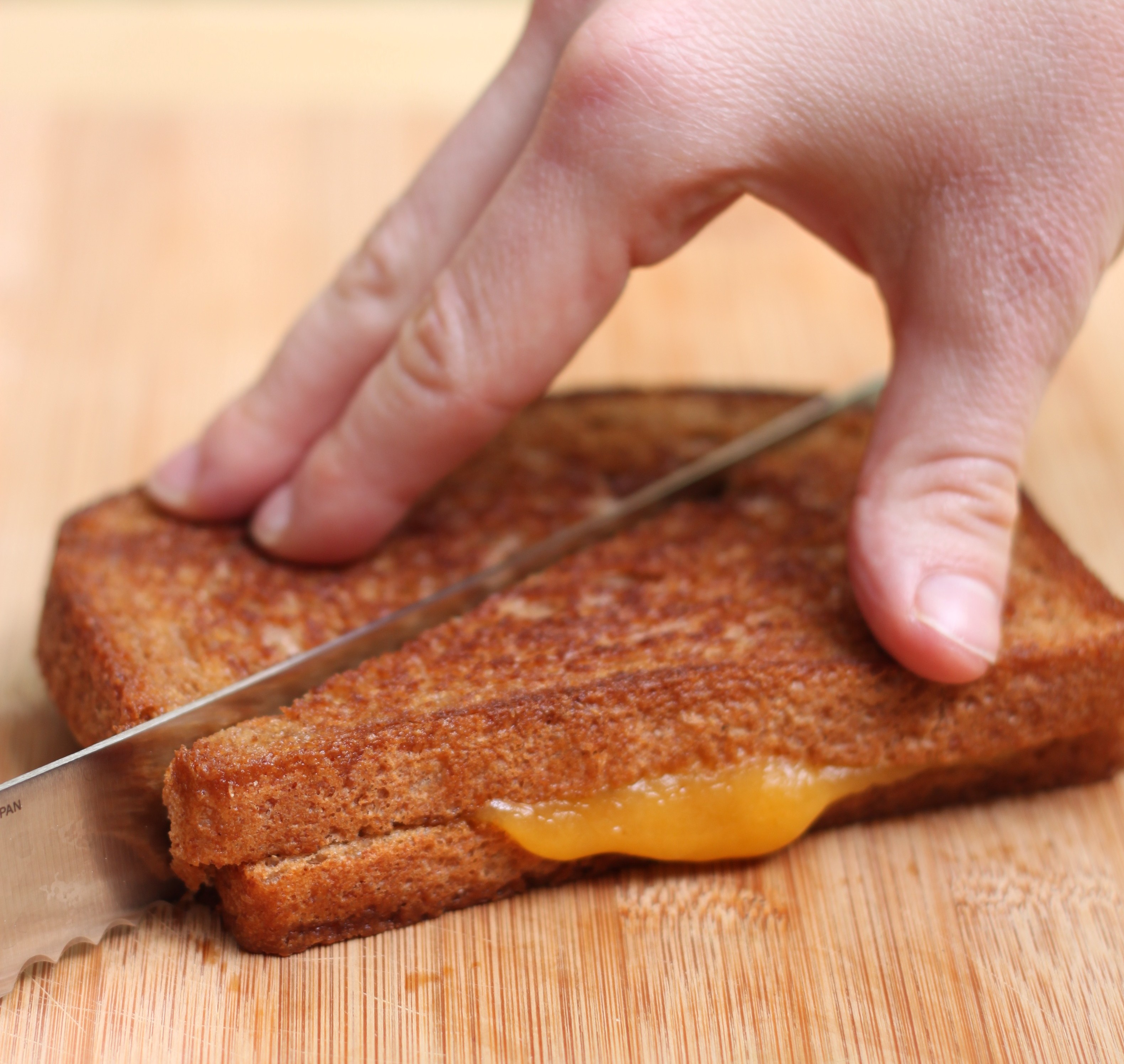 Slice grilled cheese in half