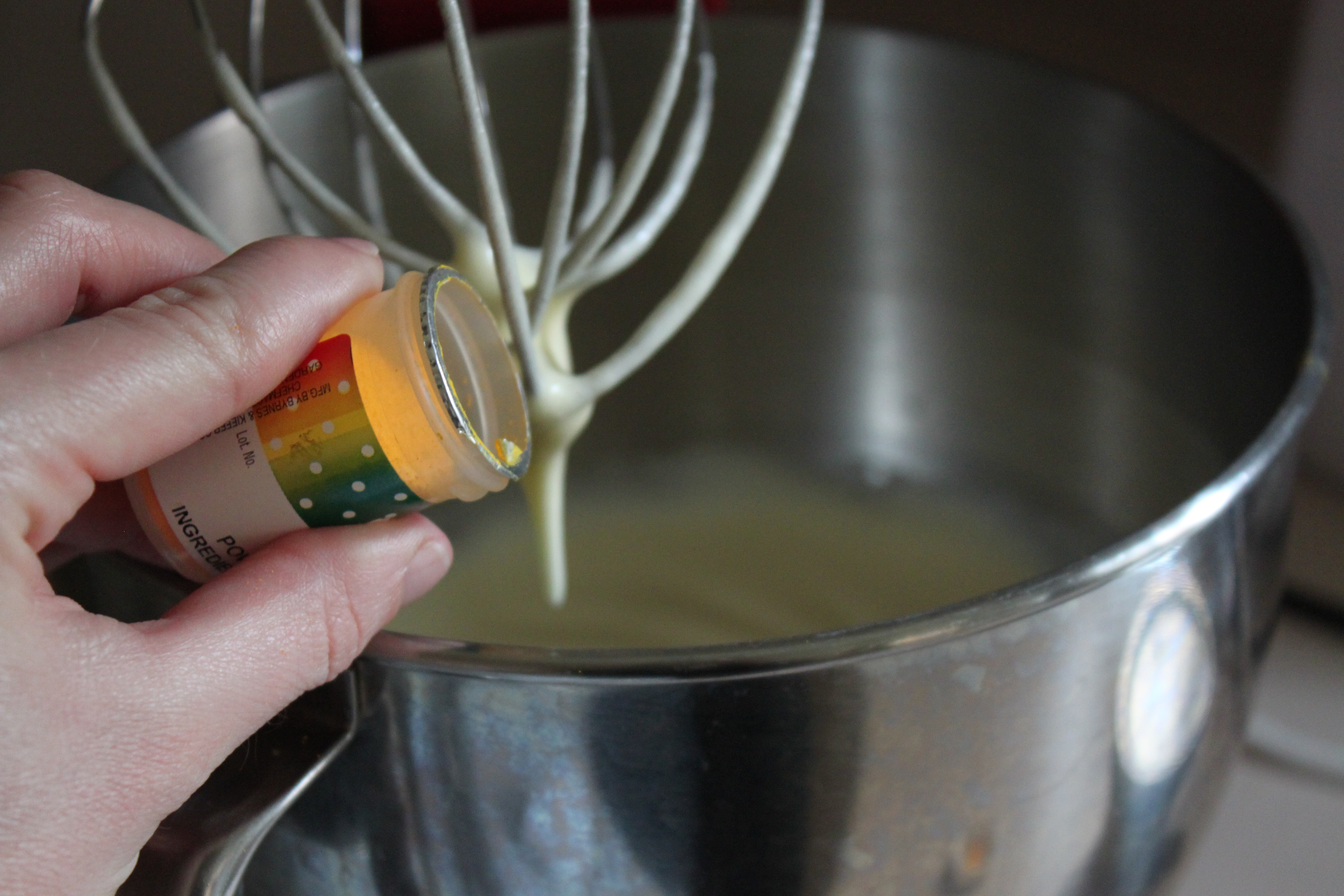 Add powdered food coloring to egg whites