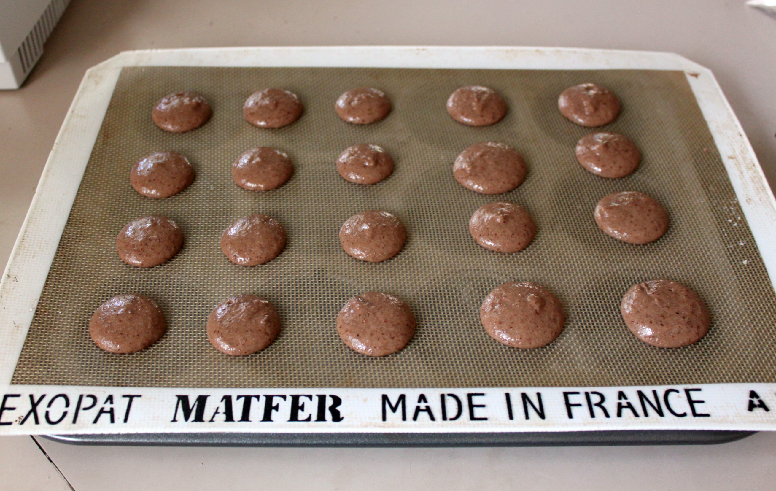 Pipe macaron batter onto prepared sheet