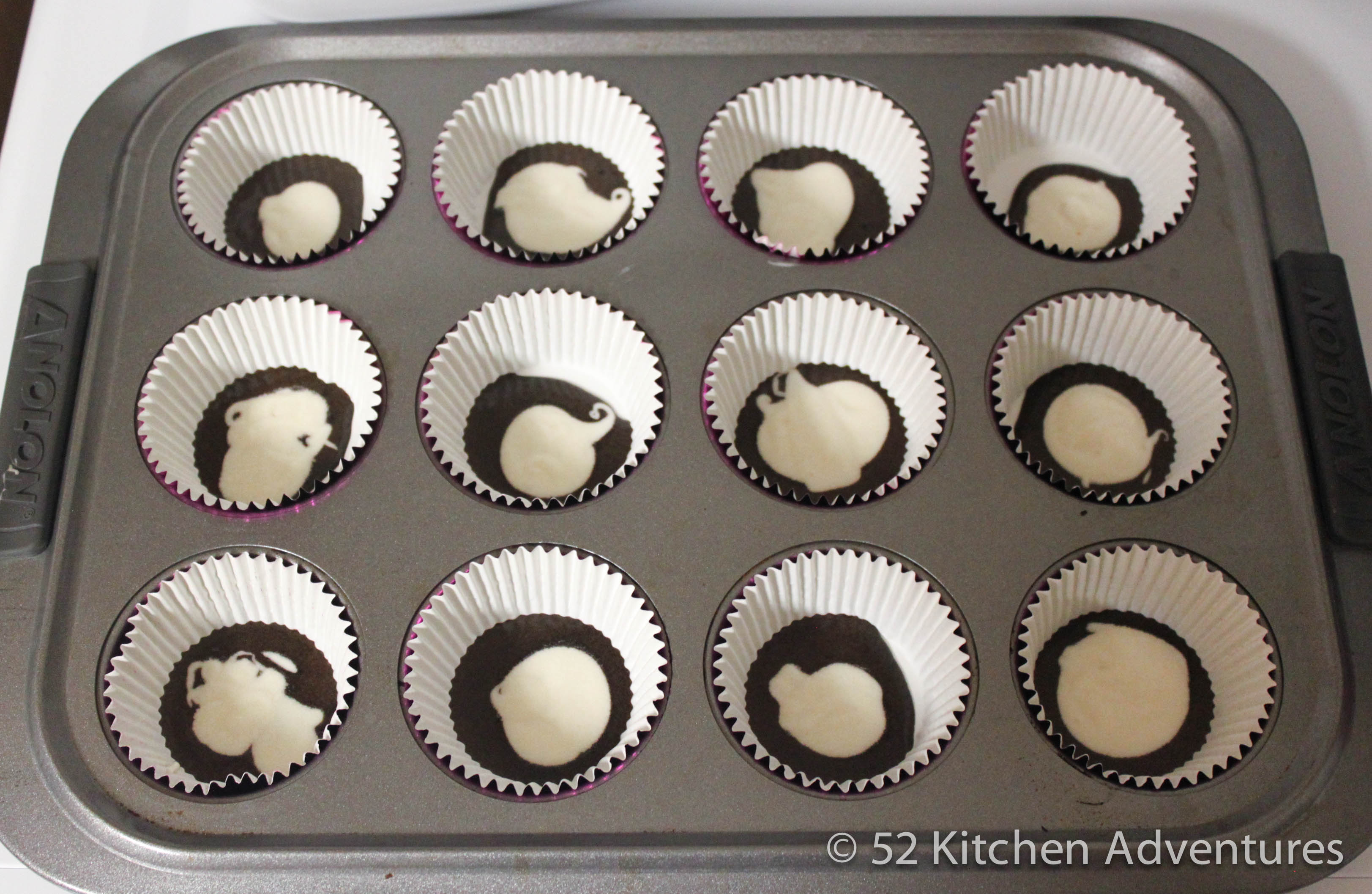 Pour 1 teaspoon of vanilla cake batter into cupcake liners