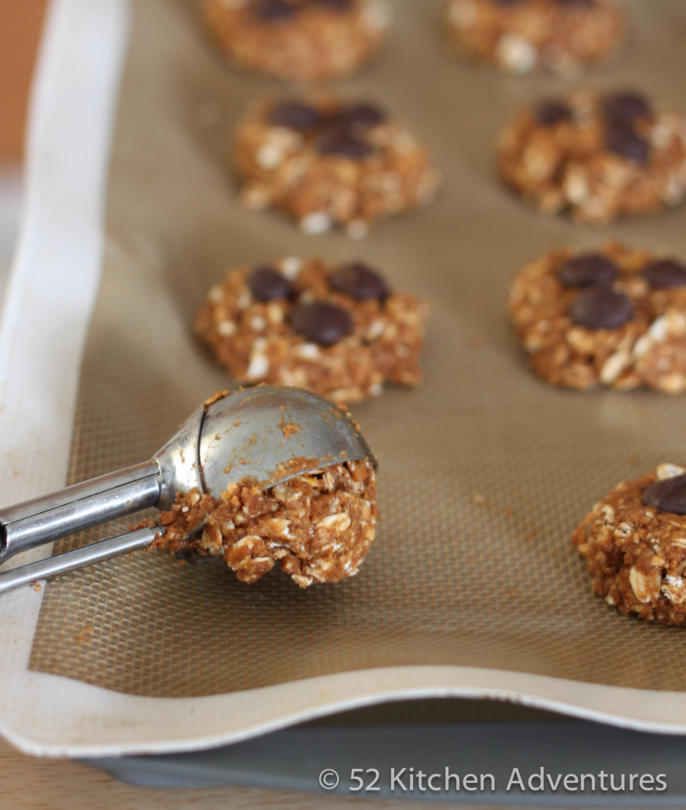 Measure cookie dough with small scoop